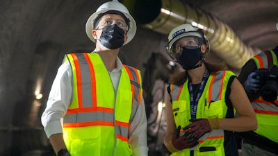 Construction project manager Gabrielle Ferro, second right, speaks with U.S. Secretary of Transportation Pete Buttigieg, during a tour of an underground tunnel for the expansion of the Hartsfield–Jackson Atlanta International Airport plane train tunnel at the Hartsfield–Jackson Atlanta International Airport on Friday, May 21 in Atlanta.