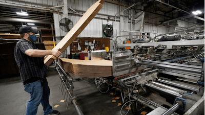 Rob Bondurant, a supervisor at Great Southern Industries, a packaging company, loads up a finishing machine in the Jackson, Miss., facility on May 28.