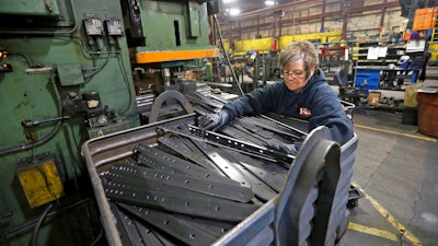 In this April 22 file photo, Marie Tibbott sorts product at EIP Manufacturing in Earlville, IA.