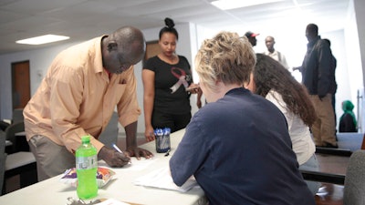 Employees of a Smithfield pork processing plant register to vote on June 3 on a contract offer from the company at the union's office in Sioux Falls, S.D. The union voted overwhelmingly against it, escalating labor negotiations.