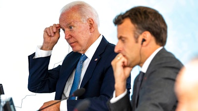 President Joe Biden talks with French President Emmanuel Macron during the final session of the G-7 summit in Carbis Bay, England on June 13.