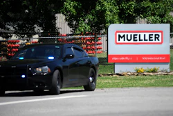 A police car guards the entrance to a Mueller Co. fire hydrant plant, Albertville, Ala., June 15, 2021.