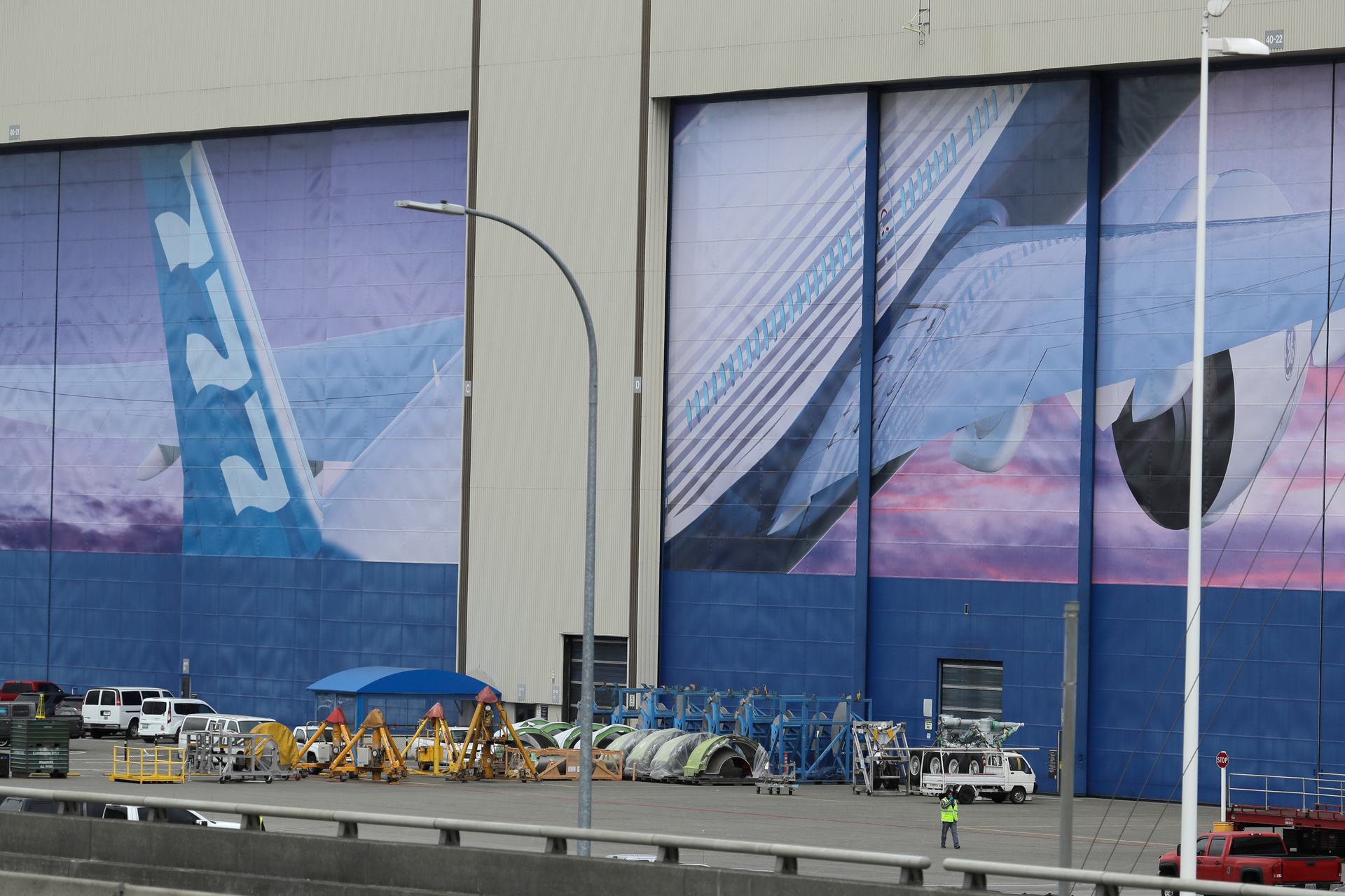 In this Monday, March 23, 2020, file photo, a worker walks near a mural of a Boeing 777 airplane at the company's manufacturing facility in Everett, Wash., north of Seattle.