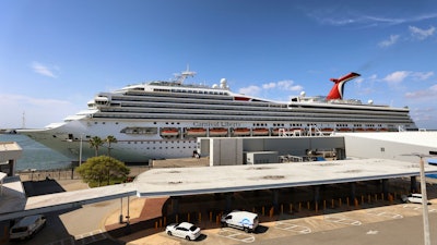 In this Wednesday, May 12, 2021, file photo, the Carnival Cruise ship 'Liberty' is docked at Port Canaveral, Fla. Carnival Corp. continues to lose billions while it waits for cruising to recover from the pandemic.