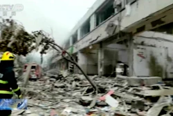 In this image taken from a video footage run by China's CCTV, a firefighter walks near the aftermath of a gas explosion in Shiyan city in central China's Hubei Province on Sunday, June 13, 2021. At least a dozen people were killed and more seriously injured Sunday after a gas line explosion tore through the residential neighborhood in central China.