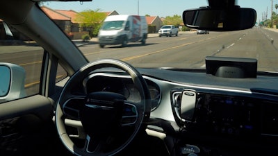 In this April 7, 2021 file photo, a Waymo minivan moves along a city street as an empty driver's seat and a moving steering wheel drive passengers during an autonomous vehicle ride in Chandler, Ariz. The U.S. government's highway safety agency has ordered automakers to report any crashes involving fully autonomous vehicles or partially automated driver assist systems. The move Tuesday, June 29, by the National Highway Traffic Safety Administration indicates the agency is taking a tougher stance on automated vehicle safety than in the past.