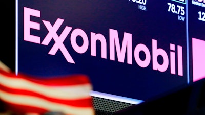 In this April 23, 2018, file photo, the logo for ExxonMobil appears above a trading post on the floor of the New York Stock Exchange. Exxon Mobil shareholders have unseated a third board member in their bid to force the oil giant to deal more aggressively with climate change. The company announced Wednesday, June 2, 2021 that three candidates nominated by a dissident group of shareholders, called Engine No. 1, had been elected to its board of directors. Preliminary tallies had two of the challengers winning seats.