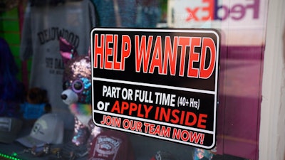 In this May 26, 2021 photo, a sign for workers hangs in the window of a shop along Main Street in Deadwood, S.D. U.S. employers added 559,000 jobs in May, an improvement from April’s sluggish gain but still evidence that many companies are struggling to find enough workers as the economy rapidly recovers from the pandemic recession.