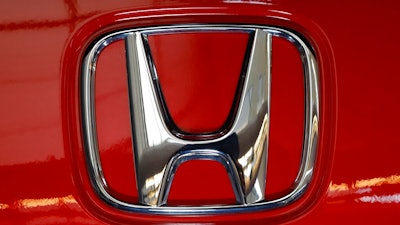 This Thursday, Feb.13, 2020 file photo shows a Honda logo on a vehicle at the 2020 Pittsburgh International Auto Show in Pittsburgh. Although General Motors will build Honda's first two fully electric vehicles for North America, in 2021 the Japanese automaker announced plans to change course and manufacture its own later in the decade.