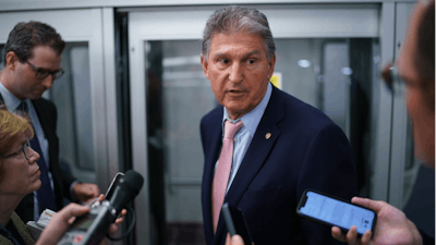 Sen. Joe Manchin, D-W.Va., a key infrastructure negotiator, pauses for reporters after working behind closed doors with other Democrats in a basement room at the Capitol in Washington, Wednesday, June 16, 2021.
