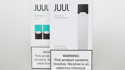 This Tuesday, Feb. 25, 2020 file photo shows packaging for an electronic cigarette and menthol pods from Juul Labs, in Pembroke Pines, Fla. Juul Labs Inc. will pay $40 million to North Carolina and take more action to prevent underage use and sales, according to a landmark legal settlement announced Monday, June 18, 2021, after years of accusations that the company had fueled an explosion in teen vaping.