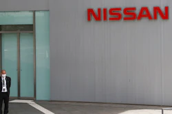 A man stands at Nissan Motor Co.'s global headquarters in Yokohama, near Tokyo, Tuesday, June 22, 2021. Nissan Chief Executive Makoto Uchida pleaded for patience from disgruntled shareholders Tuesday, promising a turnaround at the Japanese automaker, which is projecting a third year of losses as it struggles to distance itself from a scandal over its former Chairman Carlos Ghosn.