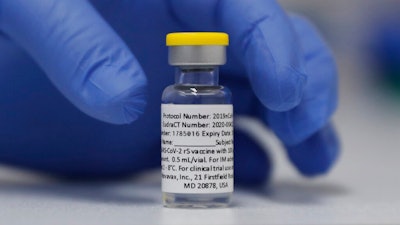 In this Wednesday, Oct. 7, 2020, file photo, a vial of the Phase 3 Novavax coronavirus vaccine is seen ready for use in the trial at St. George's University hospital in London. Novavax says its vaccine appears effective against COVID-19 in a large study, including against variants. Results from the study in the U.S. and Mexico were released on Monday, June 14, 2021.
