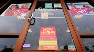 A Now Hiring sign at a business in Richmond, Va., Wednesday, June 2, 2021. U.S. employers posted a record 9.3 million job openings in April as the U.S. economy reopens at break-neck speed. Openings were up 12% from 8.3 million in March.