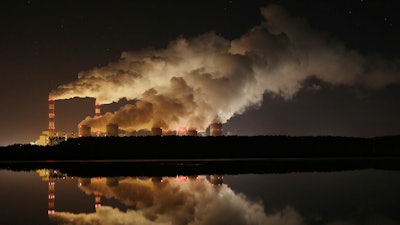 In this Wednesday, Nov. 28, 2018 file photo, clouds of smoke are pictured over Europe's largest lignite power plant in Belchatow, central Poland.