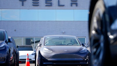 This Jan. 24, 2021 photo shows unsold 2021 Model 3 sedan at a Tesla dealership in Littleton, Colo. Tesla’s Model 3 has regained its top safety pick designations from two key groups after losing them recently. On Tuesday, June 29, the IIHS said that it recently completed new evaluations of the camera-based front crash prevention system that comes with certain Tesla Model 3 vehicles.