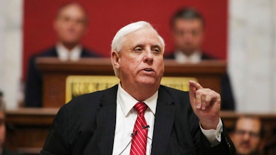 In this Wednesday, Jan. 8, 2020, file photo, West Virginia Governor Jim Justice delivers his annual State of the State address in the House Chambers at the state capitol, in Charleston, W.Va. Gov. Justice confirmed on Tuesday, June 1, 2021, that he is personally liable for $700 million in loans taken by his coal companies from a lender in the United Kingdom that went bankrupt. The Republican governor took shots at the bankrupt Greensill Capital U.K. and said “it is a burden on our family beyond belief.”