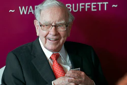 In this May 5, 2019, file photo Warren Buffett, Chairman and CEO of Berkshire Hathaway, smiles as he plays bridge following the annual Berkshire Hathaway shareholders meeting in Omaha, Neb. Warren Buffett made a $4.1 billion annual philanthropic contribution and said he’s halfway through his goal of giving away most of his money. The billionaire investor also said he is stepping down as trustee of the Bill and Melinda Gates Foundation as he exits all other corporate boards.