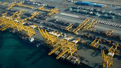 In this Sunday, Jan. 3, 2010 file photo, container ships dock at the Dubai Port in the Jebel Ali Free Zone about 40 kilometers (25 miles) south of Dubai, United Arab Emirates. Authorities in Dubai say a container ship anchored at its huge port caught fire, causing an explosion that sent tremors across the commercial hub of the United Arab Emirates. The Twitter post from Dubai’s state-run media office said the fire was reported on the ship late Wednesday, July 7, 2021.