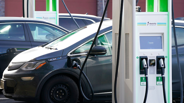 A Chevrolet Bolt charges at an Electrify America site, Lakewood, Colo., Dec. 21, 2020.