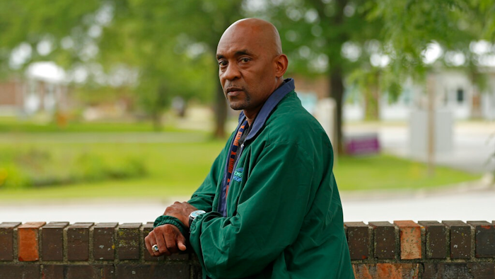 Crosby Smith, care provider at Ludeman Developmental Center, a state home for the developmentally disabled, poses for a portrait near the center premise, Thursday, July 8, 2021 in Park Forest, Ill. Smith and his fiancee were among numerous staff and residents at the Ludeman Developmental Center who contracted the virus last year. He said the hazard money helped pay down credit cards and avoid further debt when buying clothing and shoes.