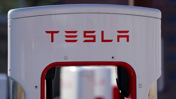 The company logo is shown at the top of a supercharger for Tesla automobiles near shops Feb. 25, 2021 in Boulder, Colo. Tesla's quarterly profit has surpassed $1 billion for the first time thanks to the electric car pioneer's ability to navigate through a pandemic-driven computer chip shortage that has caused major headaches for other automakers. The financial milestone announced Monday, July 26, 2021 extended a two-year run of prosperity that has erased questions about Tesla’s long-term viability raised during its early years of losses and production problems.