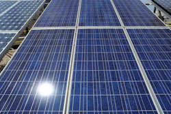 Sunlight reflects off solar panels on the roof of the older part of the Alabama Power building in Birmingham, Ala., Aug. 9, 2012.