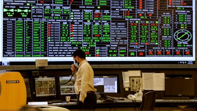 A Saudi Aramco engineer monitors the central control room of the Khurais oil field east-northeast of Riyadh, June 28, 2021.