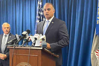 Acting U.S. Attorney Vipal J. Patel, center, accompanied by FBI Special Agent in Charge Chris Hoffman, speaks during a news conference in Cincinnati, Thursday, July 22, 2021. Federal authorities say Akron-based FirstEnergy Corp. would pay a $230 million penalty and fully cooperate as part of an agreement announced Thursday to settle federal charges against the company in a sweeping bribery scheme in Ohio.