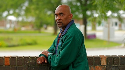 Crosby Smith, care provider at Ludeman Developmental Center, a state home for the developmentally disabled, poses for a portrait near the center premise, Thursday, July 8, 2021 in Park Forest, Ill. Smith and his fiancee were among numerous staff and residents at the Ludeman Developmental Center who contracted the virus last year. He said the hazard money helped pay down credit cards and avoid further debt when buying clothing and shoes.