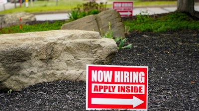 Hiring signs posted outside a gas station in Cranberry Township, Pa., May 5, 2021.