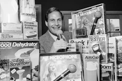 In this Wednesday, Dec. 8, 1982 file photo, Ron Popeil, the man behind those late-night, rapid-fire television commercials that sell everything from the Mr. Microphone to the Pocket Fisherman to the classic Veg-a-Matic, sits surrounded by his wares in his office in Beverly Hills, Calif. Ron Popeil, the quintessential TV pitchman and inventor known to generations of viewers for hawking products including the Veg-O-Matic, the Chop-O-Matic, Mr. Microphone and the Showtime Rotisserie and BBQ, died Wednesday, July 28, 2021 his family said.