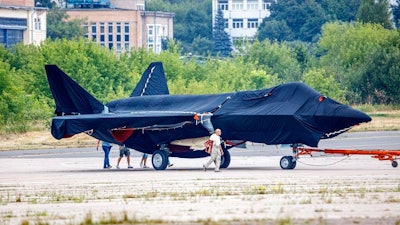 Hidden under tarpaulin, a prospective Russian fighter jet is being towed to a parking spot before its presentation at the Moscow international air show in Zhukovsky outside Moscow, Russia, Thursday, July 15, 2021. Russian aircraft makers say they will present a prospective new fighter jet at a Moscow air show that opens next week. The new warplane hidden under tarpaulin was photographed being towed to a parking spot across the airfield in Zhukovsky outside Moscow. That's where MAKS-2021 International Aviation and Space Salon opens on Tuesday. Russian President Vladimir Putin is set to visit the show’s opening.