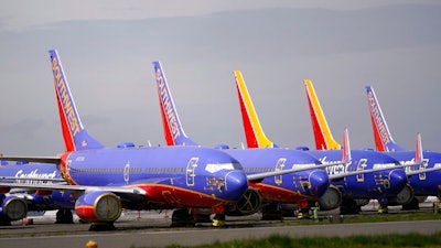 A line of Southwest Air Boeing 737 jets are parked near the company's production plant while being stored at Paine Field Friday, April 23, 2021, in Everett, Wash. Boeing reported its first quarterly profit since 2019 and revenue topped expectations, as the giant aircraft maker tries to dig out from the most difficult stretch in its history. Boeing said Wednesday, July 28, 2021, that it earned $567 million in the second quarter, compared with a $2.4 billion loss a year ago.