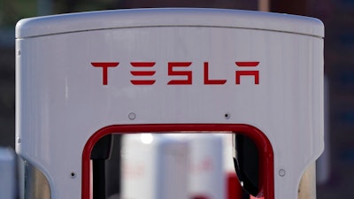 The company logo is shown at the top of a supercharger for Tesla automobiles near shops Feb. 25, 2021 in Boulder, Colo. Tesla's quarterly profit has surpassed $1 billion for the first time thanks to the electric car pioneer's ability to navigate through a pandemic-driven computer chip shortage that has caused major headaches for other automakers. The financial milestone announced Monday, July 26, 2021 extended a two-year run of prosperity that has erased questions about Tesla’s long-term viability raised during its early years of losses and production problems.