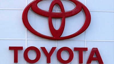 This Aug. 15, 2019, file photo shows the Toyota logo on a dealership in Manchester, N.H. In a deal announced Wednesday, July 21, 2021, Japan’s top automaker Toyota is adding makers specializing in tiny “kei” cars, Daihatsu and Suzuki, to a partnership in commercial vehicles set up with Hino and Isuzu earlier this year.