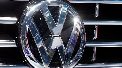 In this Sept. 22, 2015, file photo, the logo of Volkswagen at a car is photographed during the Car Show in Frankfurt, Germany. Luxury brands Audi and Porsche are fattening the bottom line at German automaker Volkswagen. The company's premium brands saw record sales in the first half of the year. That helped the Wolfsburg-based auto giant make more money than it did even before the pandemic. The company made 11.4 billion euros, or $13.5 billion, in the first half of the year.