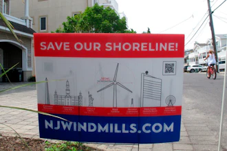 This July 8, 2021 photo shows a sign in Ocean City, N.J. urging opposition to offshore wind projects.