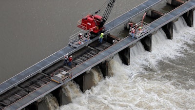 Workers open bays of the Bonnet Carre Spillway to divert rising water from the Mississippi River to Lake Pontchartrain, Norco, La., May 10, 2019.