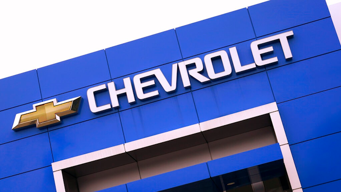 The Chevrolet logo is displayed on the facade of a dealership , Tuesday, Aug. 3, 2021, in Woburn, Mass. Despite a computer chip shortage that temporarily closed some of its factories, General Motors made a healthy $2.8 billion second-quarter net profit in the second quarter.