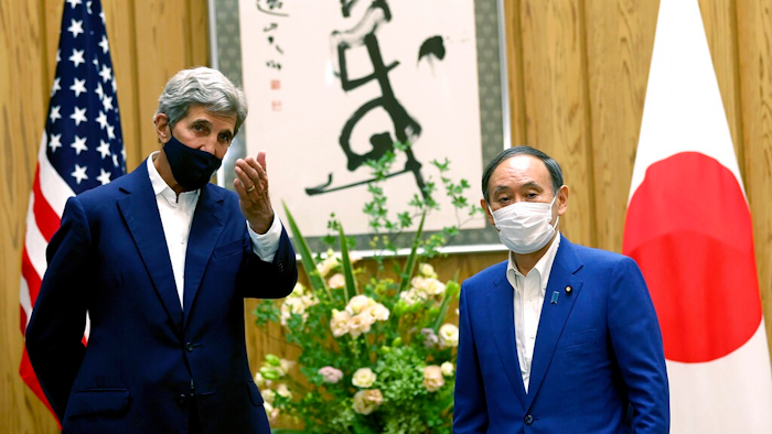 U.S. Special Presidential Envoy for Climate John Kerry, left, gestures to Japanese Prime Minister Yoshihide Suga during a meeting at Suga's official residence in Tokyo Tuesday, Aug. 31, 2021. Kerry met with Japan's top diplomat to push efforts to fight climate change ahead of a United Nations conference in November.