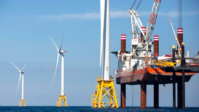 In this March 28, 2018, file photo, a North Atlantic right whale feeds on the surface of Cape Cod bay off the coast of Plymouth, Mass. A group from the island of Nantucket, Mass., called ACK Residents Against Turbines, filed a federal lawsuit Wednesday, Aug. 25, 2021, to block the construction of dozens of wind turbines off the coast of Nantucket and nearby Martha's Vineyard. ACK Residents Against Turbines say Vineyard Wind's proposed project poses a risk to the endangered Northern Atlantic right whale.
