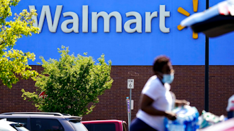 A shopper loads items into her car in the parking lot of a Walmart in Willow Grove, Pa., Wednesday, May 19, 2021. Walmart says it will start commercializing its delivery service, using contract workers, autonomous vehicles and even drones to deliver other retailers' products directly to their customers' homes as fast as just a few hours.