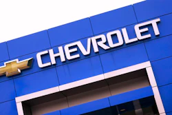 The Chevrolet logo is displayed on the facade of a dealership , Tuesday, Aug. 3, 2021, in Woburn, Mass. Despite a computer chip shortage that temporarily closed some of its factories, General Motors made a healthy $2.8 billion second-quarter net profit in the second quarter.