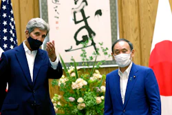U.S. Special Presidential Envoy for Climate John Kerry, left, gestures to Japanese Prime Minister Yoshihide Suga during a meeting at Suga's official residence in Tokyo Tuesday, Aug. 31, 2021. Kerry met with Japan's top diplomat to push efforts to fight climate change ahead of a United Nations conference in November.