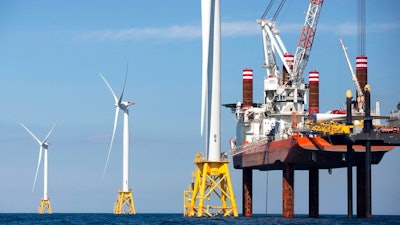 In this March 28, 2018, file photo, a North Atlantic right whale feeds on the surface of Cape Cod bay off the coast of Plymouth, Mass. A group from the island of Nantucket, Mass., called ACK Residents Against Turbines, filed a federal lawsuit Wednesday, Aug. 25, 2021, to block the construction of dozens of wind turbines off the coast of Nantucket and nearby Martha's Vineyard. ACK Residents Against Turbines say Vineyard Wind's proposed project poses a risk to the endangered Northern Atlantic right whale.