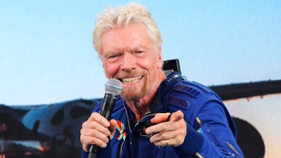 In this Sunday, July 11, 2021 file photo, Richard Branson answers students' questions during a news conference at Spaceport America near Truth or Consequences, N.M. Virgin Galactic is selling tickets for space flights again, just weeks after founder Richard Branson rode a rocket-powered plane to more than 50 miles above the Earth. Tickets aren't cheap. Virgin Galactic is setting prices to start at $450,000 a seat. The company announced the sales as it reported Thursday, Aug. 5, 2021 that it lost $94 million in the second quarter. Costs for overhead and sales jumped from a year earlier. Revenue was just $571,000, barely enough to cover one seat on a future flight.