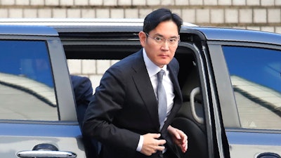 In this Nov. 22, 2019, file photo, Samsung Electronics Vice Chairman Lee Jae-yong gets out of a car at the Seoul High Court in Seoul, South Korea. A day ahead of his release on parole, billionaire Samsung scion Lee Jae-yong appeared in court Thursday, Aug. 12, 2021, for an ongoing trial over charges of financial crimes, a reminder of his looming legal risks even as he leaves prison.