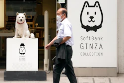 A man walks in front of a SoftBank shop in Tokyo on July 29, 2021. Japanese technology company SoftBank’s fiscal first quarter earnings dropped 39% because of the absence of the cash from selling Sprint, which boosted profits a year ago.