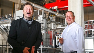 Germany's center-right candidate to replace Angela Merkel as chancellor in the upcoming elections and Christian Democratic Union chairman, Armin Laschet, right, talks to Elon Musk, Tesla CEO, during a visit at the construction side of the Tesla Gigafactory in Gruenheide near Berlin, Germany, Friday, Aug. 13, 2021. Laschest visits the factory as part of his election campaign for the upcoming national elections on Sept. 26, 2021.